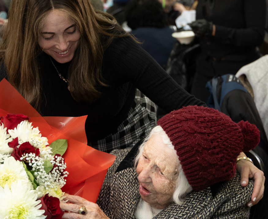 224 A young woman surprises a survivor with flowers