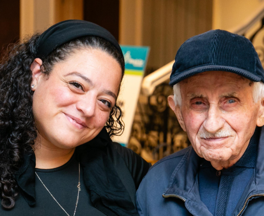 An older survivor smiling with a younger woman