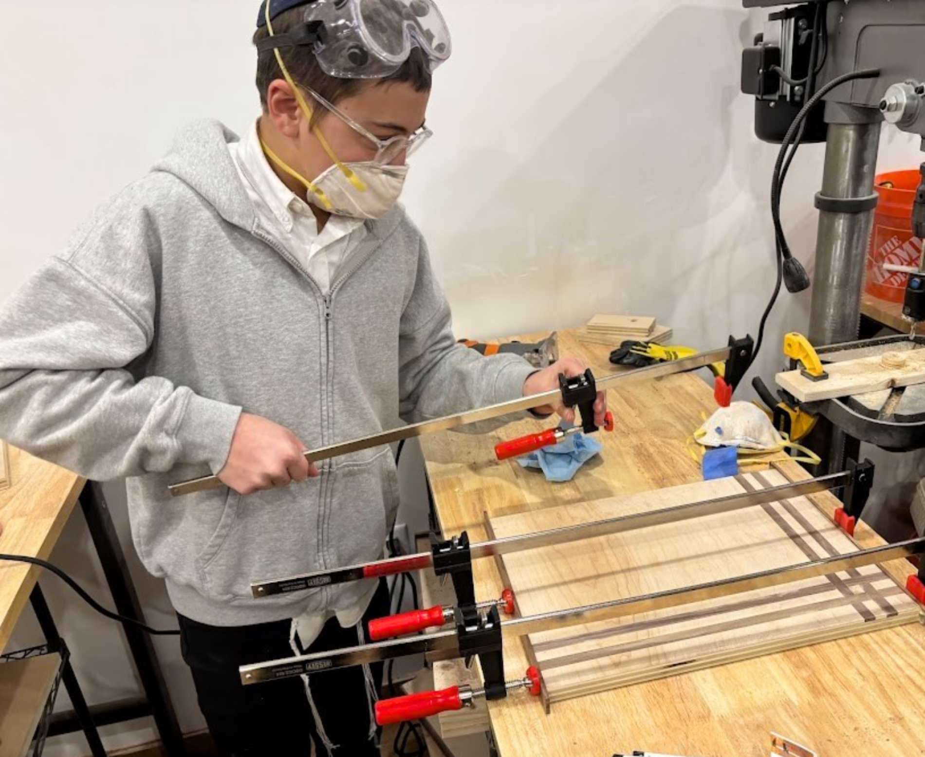 kid constructing something with wood and tools