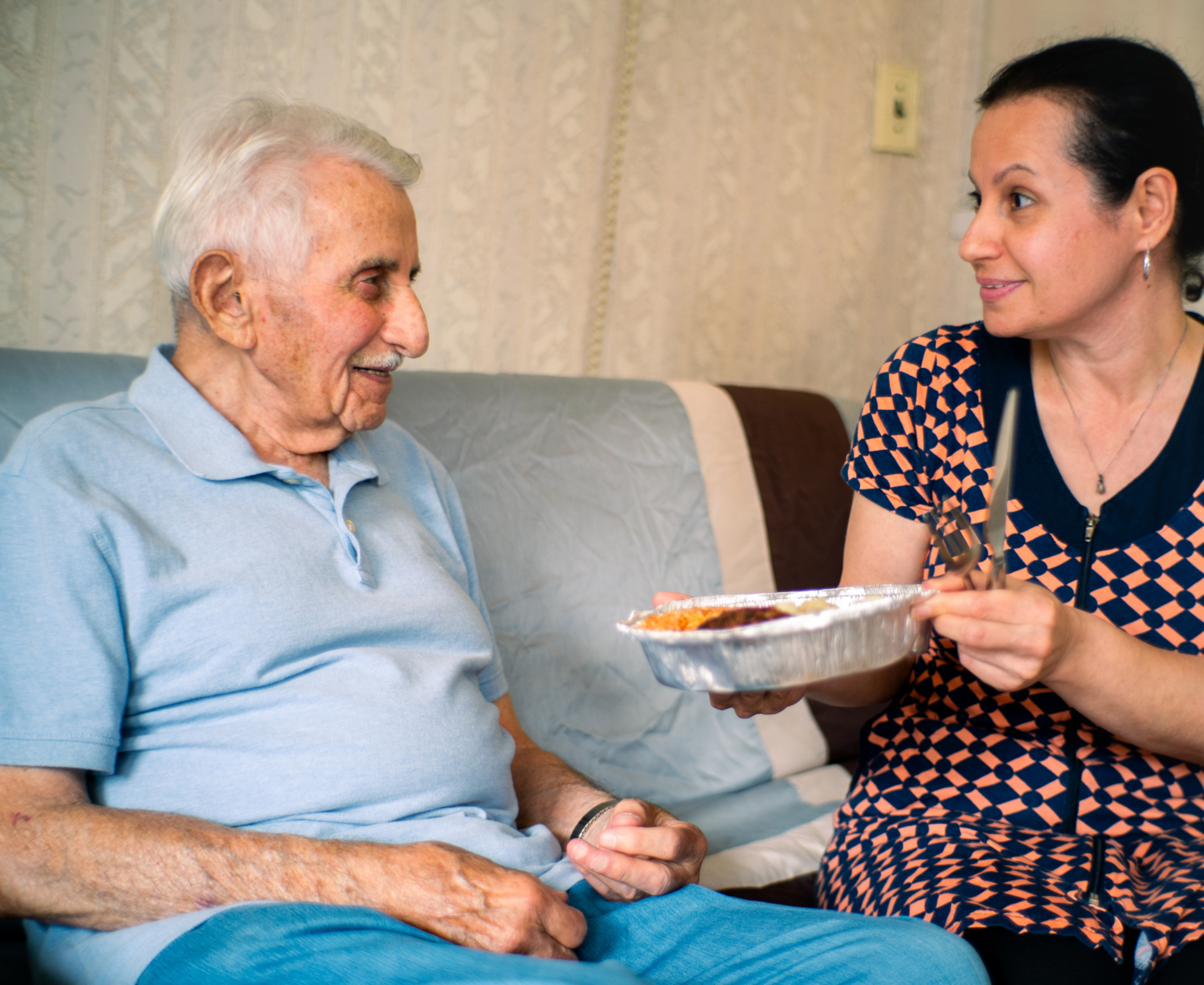 a woman giving a man food