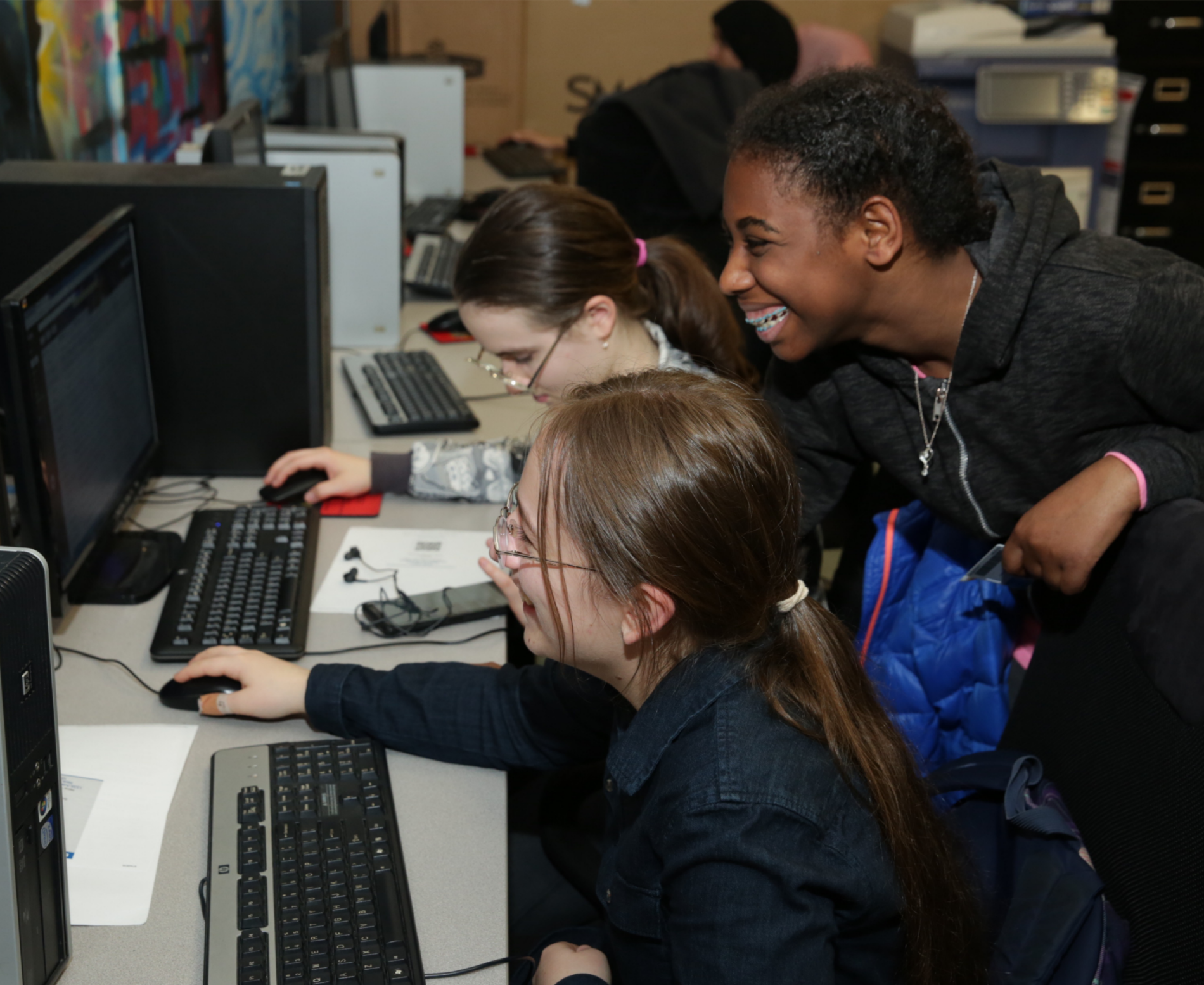 girls looking at a computer