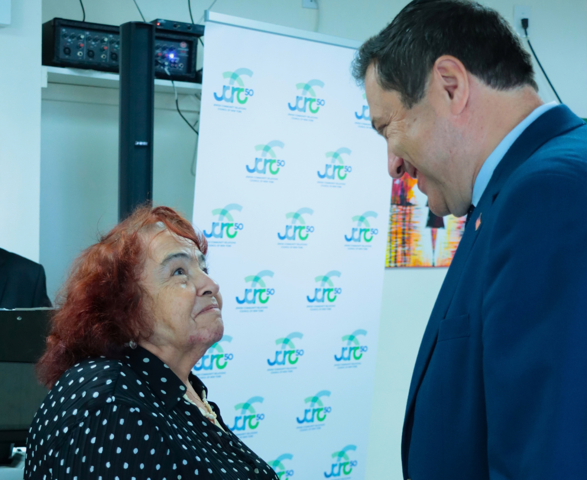 A Holocaust survivor speaking to a public official