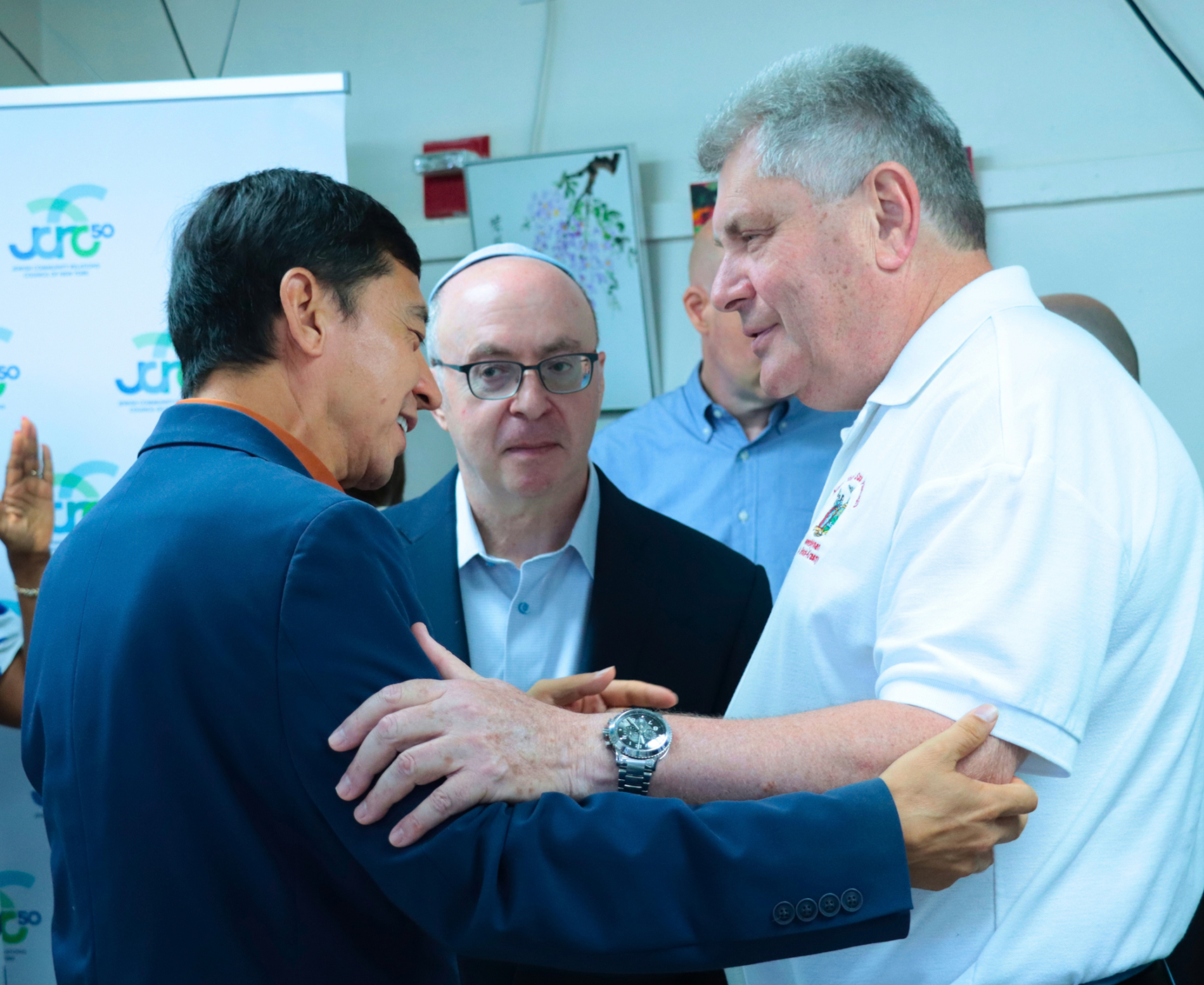 Public officials shaking hands and speaking