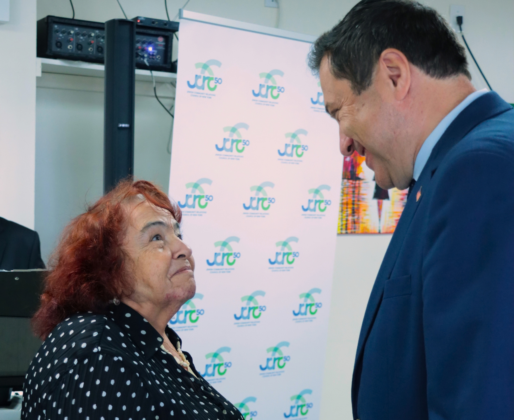 A Holocaust survivor speaking to a public official
