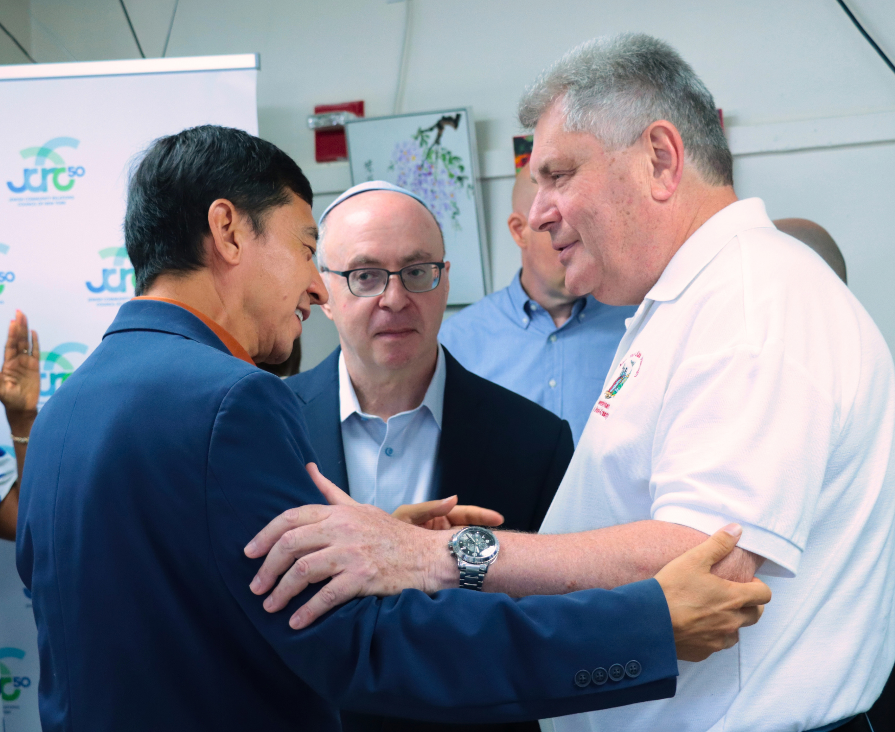 Public officials shaking hands and speaking
