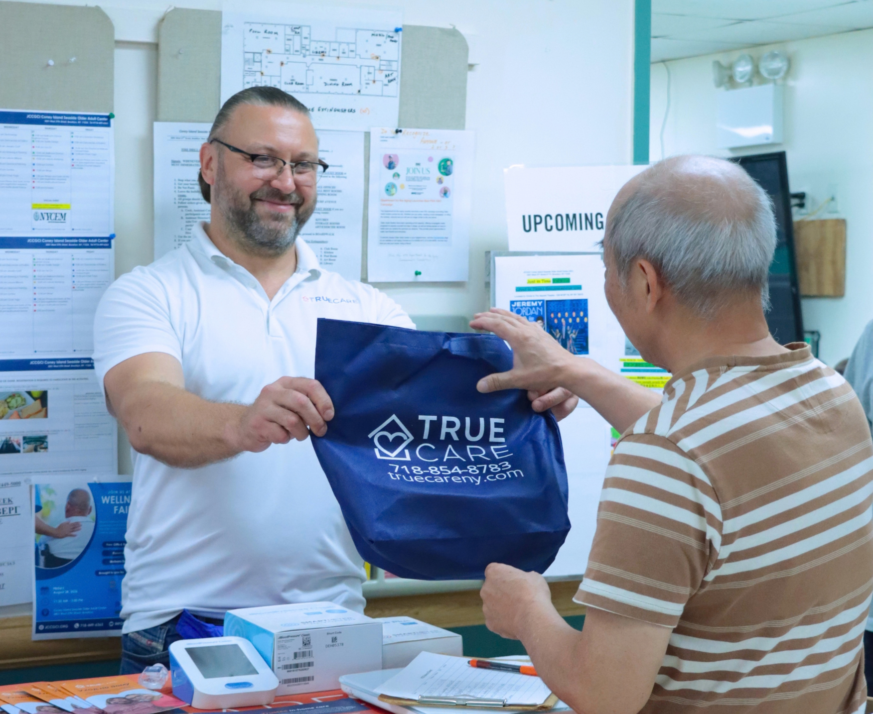 258 True Care rep handing a branded bag to an older adult