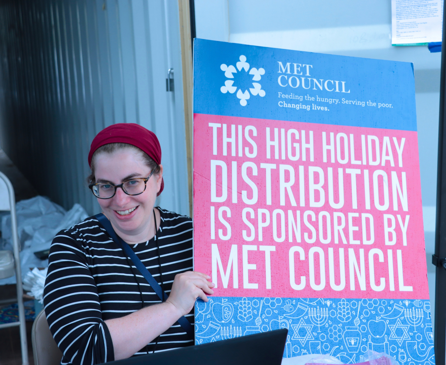 Sara Chamama with the Met Council sign