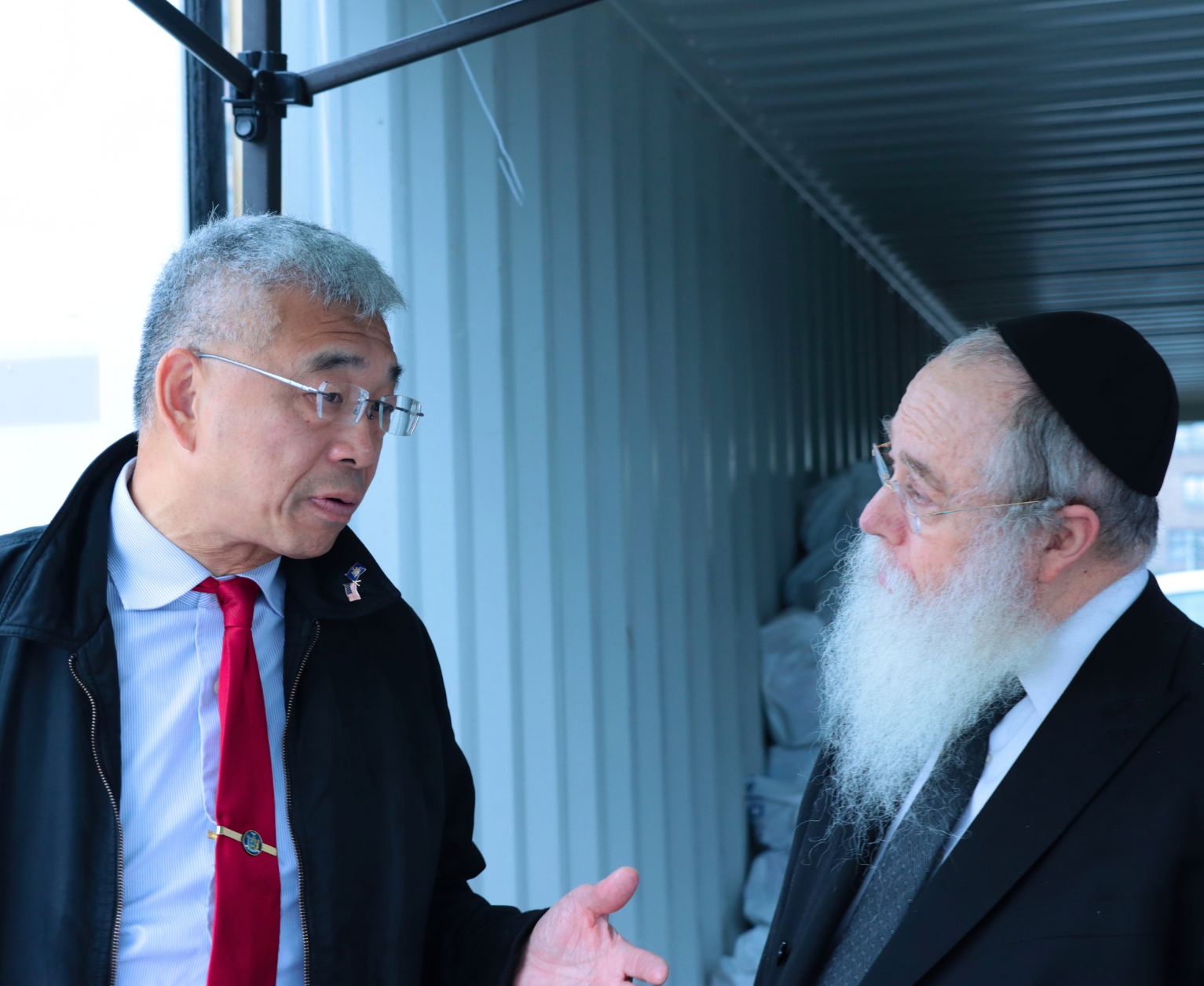 Rabbi Wiener speaking with Assemblyman Lester Chang