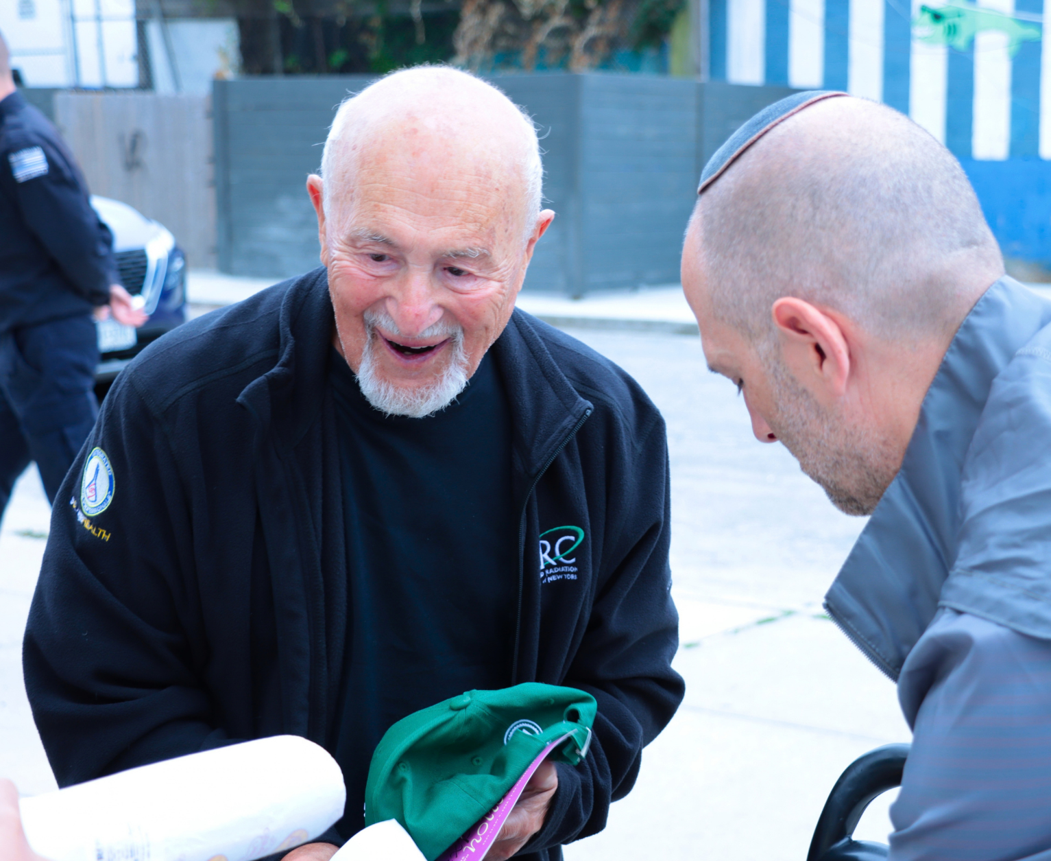 A volunteer handing food to an older adult client